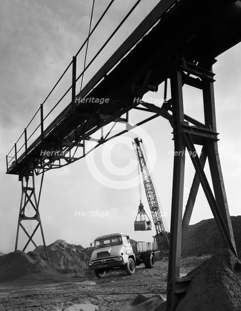 Loading a Ford Thames Trader tipper lorry, Finningley, near Doncaster, South Yorkshire, 1966. Creator: Michael Walters.
