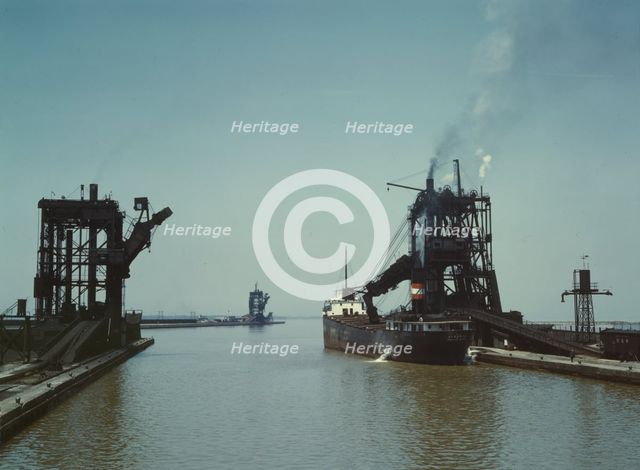 Loading a freighter with coal at one of the three coal docks owned by the..., Sandusky, Ohio, 1943. Creator: Jack Delano.