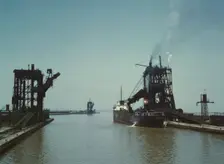Loading a freighter with coal at one of the three coal docks owned by the..., Sandusky, Ohio, 1943. Creator: Jack Delano