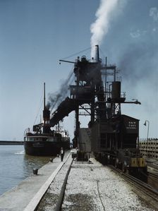 Loading a lake freighter with coal at the Pennsylvania R.R. coal docks...Sandusky, Ohio, 1943. Creator: Jack Delano