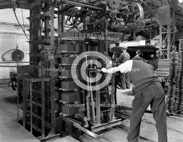 Loading a palletising machine with bricks, Whitwick Brickworks, Coalville, Leicestershire, 1963. Artist: Michael Walters