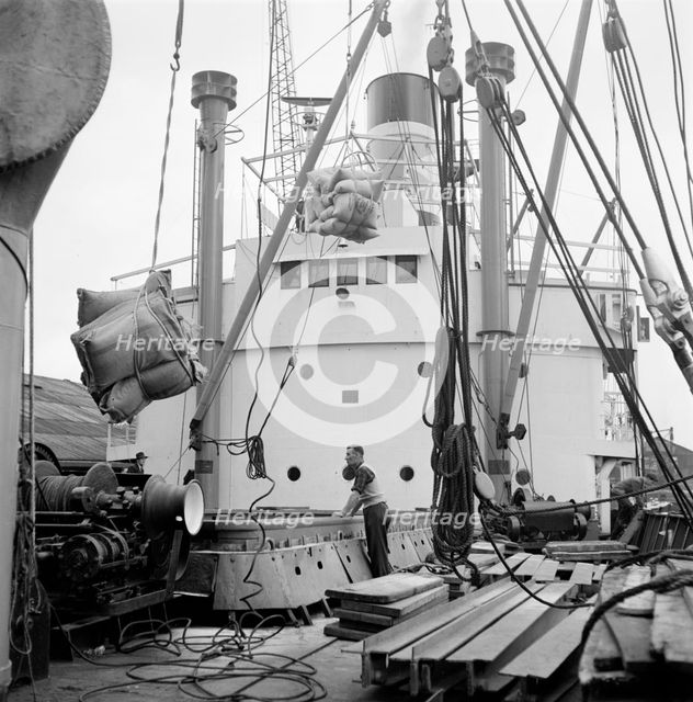 Loading a ship at the North Quay, West India Docks, London, c1945-c1965. Artist: SW Rawlings