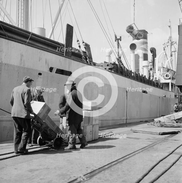 Loading a ship at the North Quay, West India Docks, London, c1945-c1965. Artist: SW Rawlings