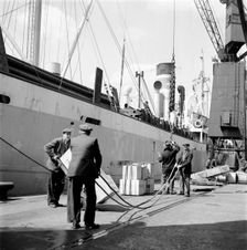 Loading a ship at the North Quay, West India Docks, London, c1945-c1965. Artist: SW Rawlings