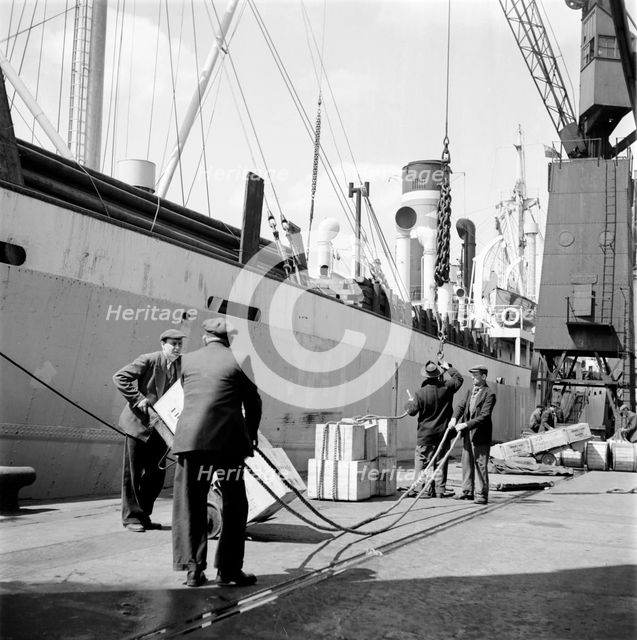 Loading a ship at the North Quay, West India Docks, London, c1945-c1965. Artist: SW Rawlings