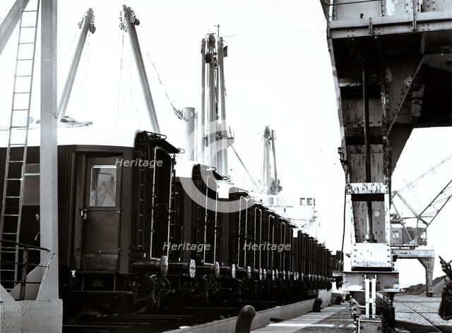 Loading and transport of train wagons in the port of Zeebrugge - Bruges, Belgium.