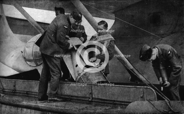 Loading bombs on to an RAF aircraft during World War II, c1940 (1943). Artist: Unknown.