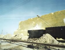 Loading box cars with sulphur, Freeport Sulphur Co., Hoskins Mound, Texas, 1943. Creator: John Vachon