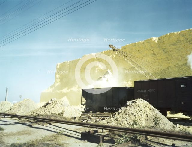 Loading box cars with sulphur, Freeport Sulphur Co., Hoskins Mound, Texas, 1943. Creator: John Vachon.