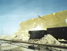Loading box cars with sulphur, Freeport Sulphur Co., Hoskins Mound, Texas, 1943. Creator: John Vachon