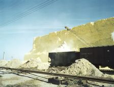 Loading box cars with sulphur, Freeport Sulphur Co., Hoskins Mound, Texas, 1943. Creator: John Vachon