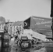 Loading boxes of fish to be shipped to hotels and restaurants at the Fulton fish..., New York, 1943. Creator: Gordon Parks