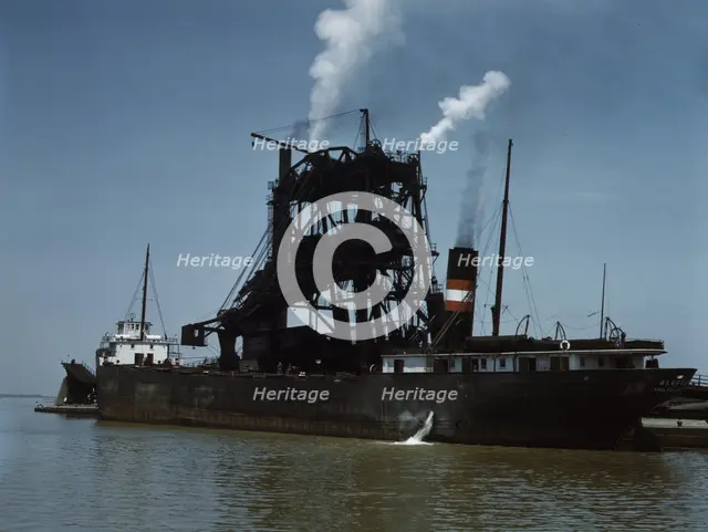 Loading coal into a freighter at one of the Pennsylvania Railroad docks, Sandusky, Ohio, 1943. Creator: Jack Delano.