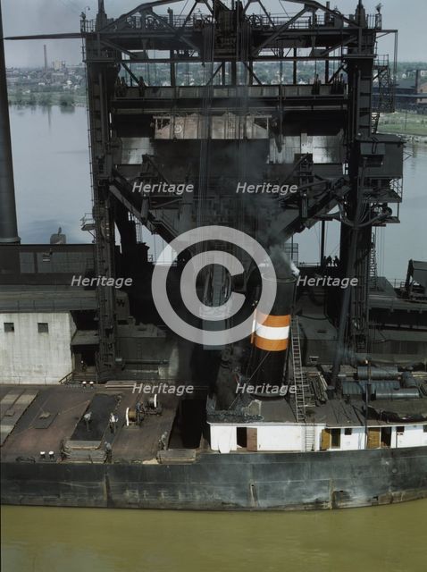 Loading coal into a lake freighter at the Pennsylvania Railroad docks, Sandusky, Ohio, 1943. Creator: Jack Delano.