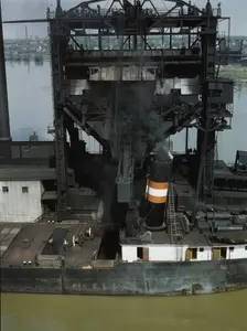 Loading coal into a lake freighter at the Pennsylvania Railroad docks, Sandusky, Ohio, 1943. Creator: Jack Delano