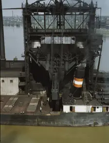 Loading coal into a lake freighter at the Pennsylvania Railroad docks, Sandusky, Ohio, 1943. Creator: Jack Delano