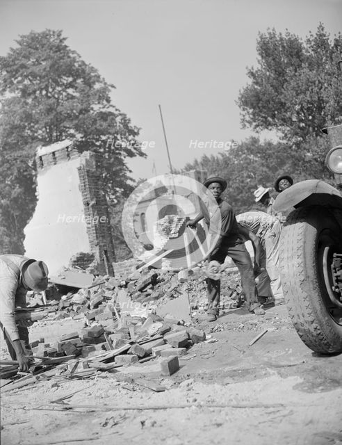 Loading debris from wrecked buildings along Independence Avenue, Washington, D.C, 1942. Creator: Gordon Parks.