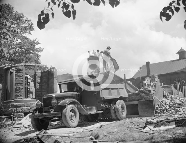 Loading debris from wrecked buildings along Independence Avenue, Washington, D.C, 1942. Creator: Gordon Parks.