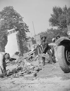Loading debris from wrecked buildings along Independence Avenue, Washington, D.C, 1942. Creator: Gordon Parks