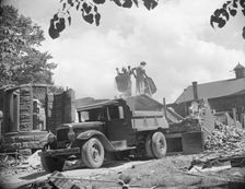 Loading debris from wrecked buildings along Independence Avenue, Washington, D.C, 1942. Creator: Gordon Parks