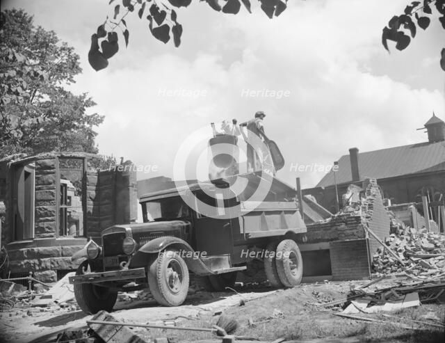 Loading debris from wrecked buildings along Independence Avenue, Washington, D.C, 1942. Creator: Gordon Parks.