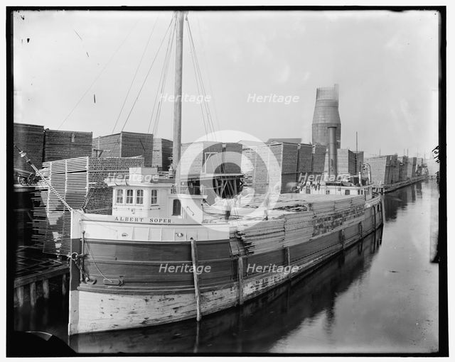 Loading lumber on steamer at lumberyards, Menominee, Mich., between 1880 and 1899. Creator: Unknown.