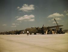 Loading new transport planes at the Consolidated Aircraft Corporation plant, Fort Worth, Texas, 1942 Creator: Howard Hollem
