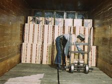 Loading oranges into a refrigerator car at a co-op orange packing plant, Redlands, Calif., 1943. Creator: Jack Delano