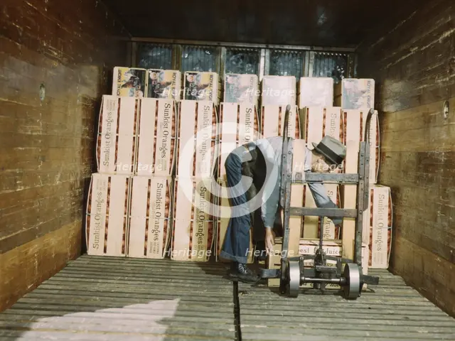 Loading oranges into a refrigerator car at a co-op orange packing plant, Redlands, Calif., 1943. Creator: Jack Delano.