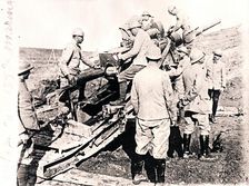 Loading shell into 155 mm gun, c1914-c1918