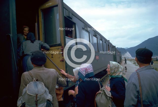 Local people boarding a train in Czechslovakia. Artist: CM Dixon Artist: Unknown