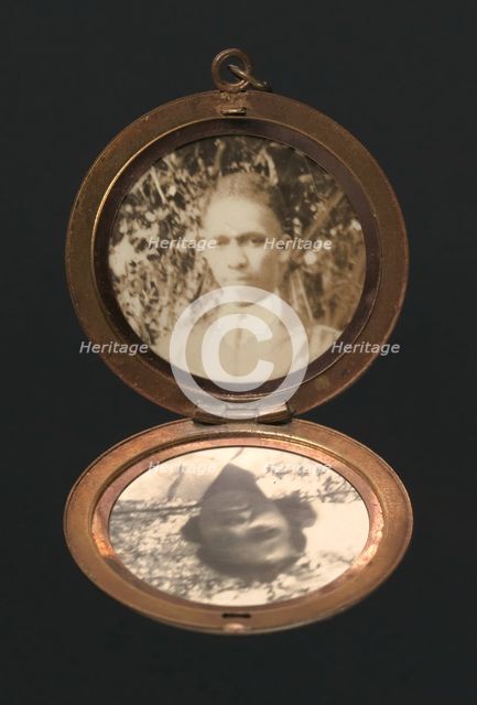 Locket with photographs of Harriette and Harry T. Moore, early to mid 20th century. Creator: Unknown.