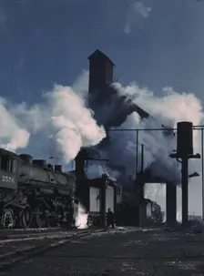Locomotives over the ash pit at the roundhouse and coaling station...Chicago, Ill., 1942. Creator: Jack Delano