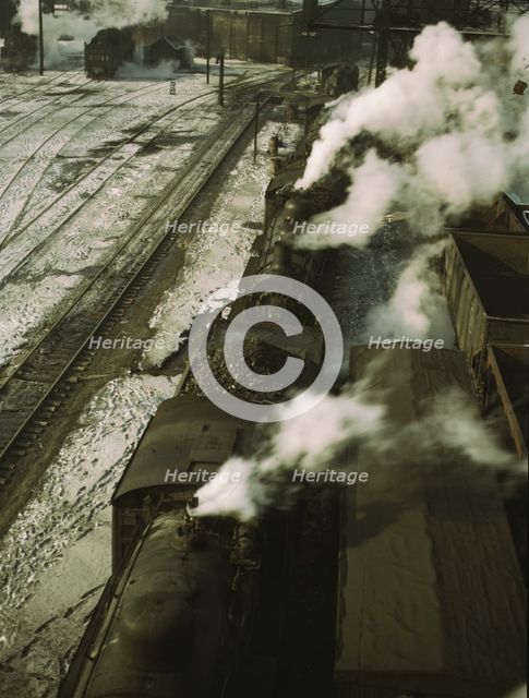 Locomotives lined up for coal, sand and water at the coaling station in the 40..., Chicago, 1942. Creator: Jack Delano.