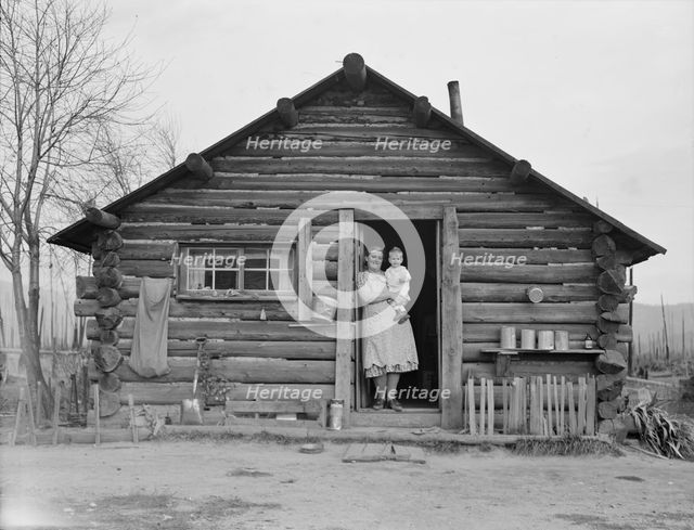 Log house now occupied and enlarged by the Halley family, Bonner County, Idaho, 1939. Creator: Dorothea Lange.
