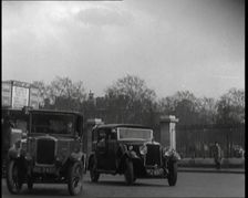 London Bus, Cars and Taxis Turning a Corner on a London Street, 1924. Creator: British Pathe Ltd