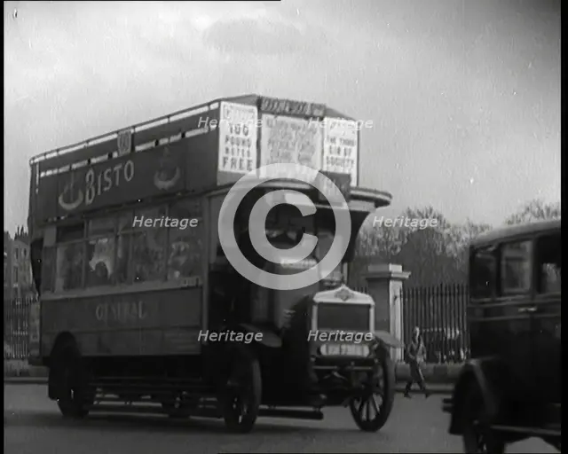 London Bus, Cars and Taxis Turning a Corner on a London Street, 1924. Creator: British Pathe Ltd.