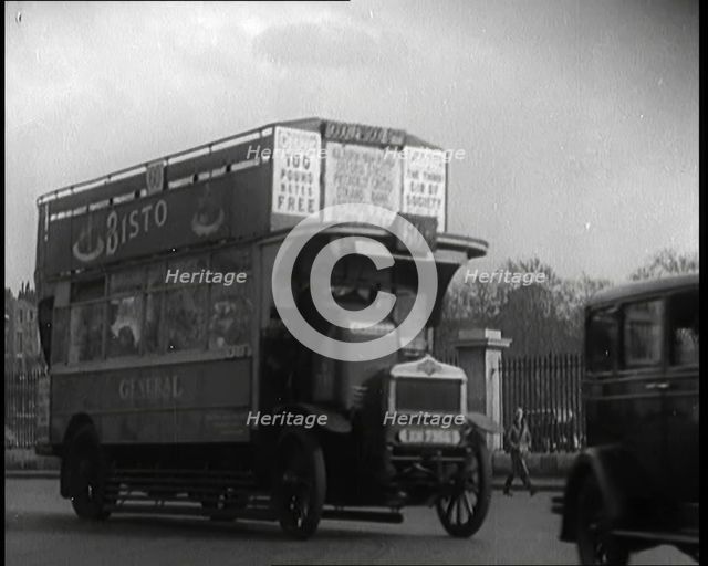 London Bus, Cars and Taxis Turning a Corner on a London Street, 1924. Creator: British Pathe Ltd.