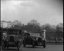 London Bus, Cars and Taxis Turning a Corner on a London Street, 1924. Creator: British Pathe Ltd