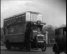 London Bus, Cars and Taxis Turning a Corner on a London Street, 1924. Creator: British Pathe Ltd