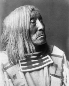 Lone Tree, an Apsaroke Indian, head-and-shoulders portrait, facing right, c1908. Creator: Edward Sheriff Curtis