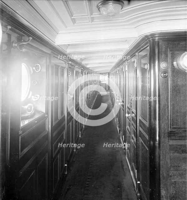 Long wood panelled corridor on steam yacht 'Venetia', 1920. Creator: Kirk & Sons of Cowes.