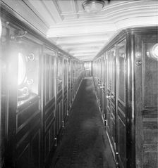 Long wood panelled corridor on steam yacht Venetia 1920. Creator: Kirk & Sons of Cowes