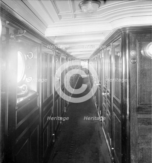Long wood panelled corridor on steam yacht 'Venetia', 1920. Creator: Kirk & Sons of Cowes.