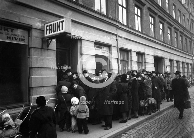 Long queue outside a shop selling fresh fruit, Malmö, Sweden, 1948. Creator: Otto Ohm.