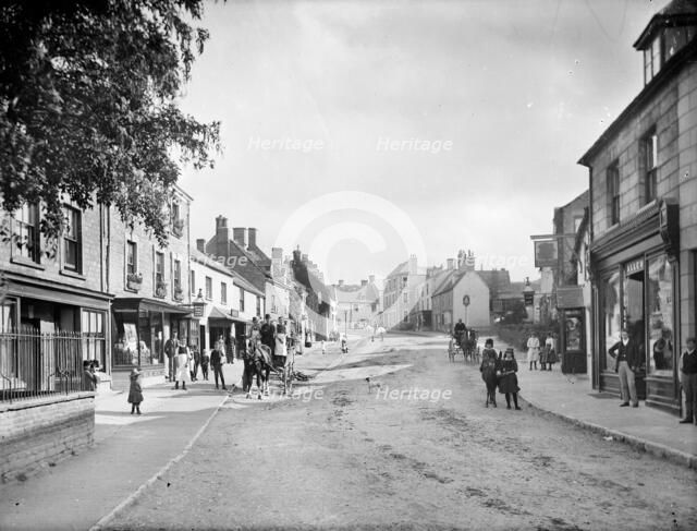 Looking up Church Street with people in the street and outside shop premises, Charlbury, Oxon, 1888. Creator: Henry Taunt.