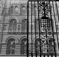 Looking up past the ornate iron gates of Westminster Palace Gardens to the facade...London, 1965-75. Creator: John Gay