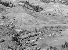 Looking down on Ola self-help co-op mill showing the upper end of Squaw..., Gem County, Idaho, 1939. Creator: Dorothea Lange