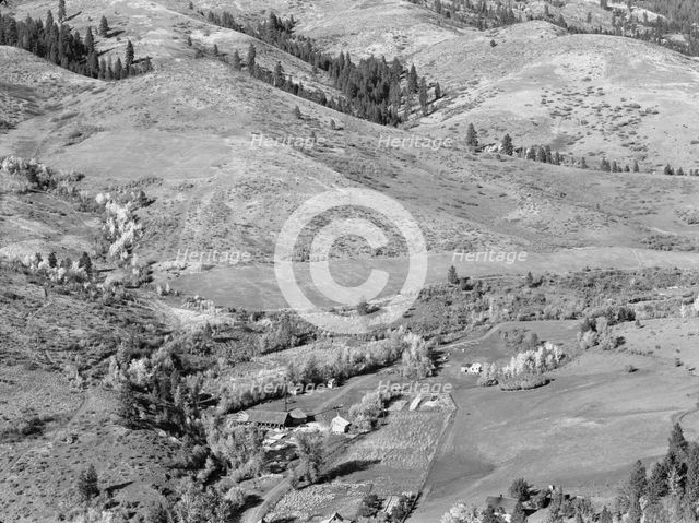 Looking down on Ola self-help co-op mill showing the upper end of Squaw..., Gem County, Idaho, 1939. Creator: Dorothea Lange.