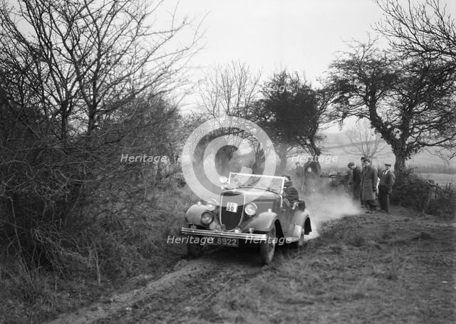 Lord Avebury's Ford V8 competing in the Sunbac Colmore Trial, Gloucestershire, 1934. Artist: Bill Brunell.